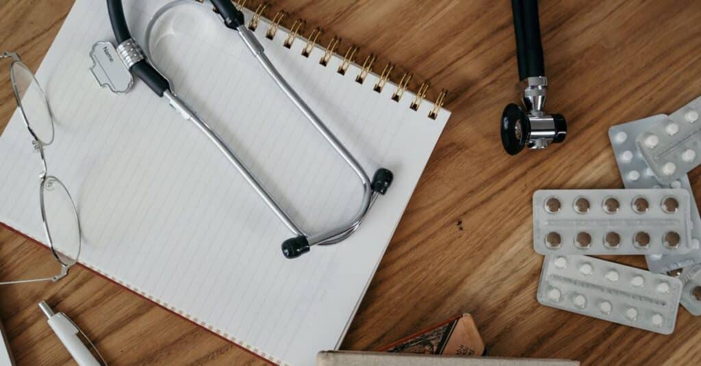 Médico à mesa revisando documentos, representando a defesa no processo ético no CRM